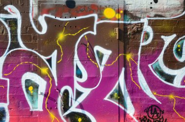 Grafiti çizimler parçası. Eski duvar boya lekeleri sokak sanatı kültür tarzı ile dekore edilmiştir. Renkli arka plan doku sıcak tonları içinde.