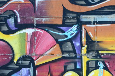 Grafiti çizimler parçası. Eski duvar boya lekeleri sokak sanatı kültür tarzı ile dekore edilmiştir. Renkli arka plan doku sıcak tonları içinde.