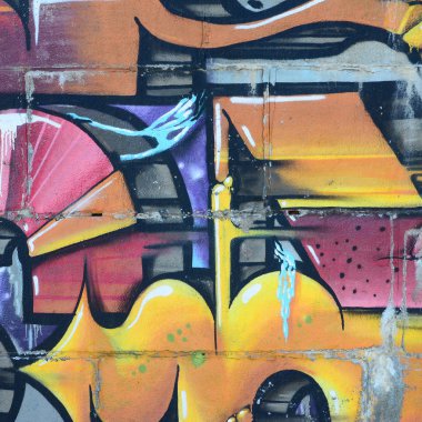 Grafiti çizimler parçası. Eski duvar boya lekeleri sokak sanatı kültür tarzı ile dekore edilmiştir. Renkli arka plan doku sıcak tonları içinde.