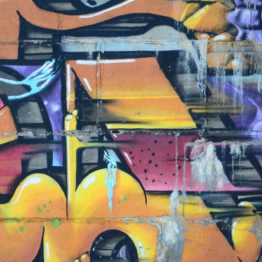 Grafiti çizimler parçası. Eski duvar boya lekeleri sokak sanatı kültür tarzı ile dekore edilmiştir. Renkli arka plan doku sıcak tonları içinde.