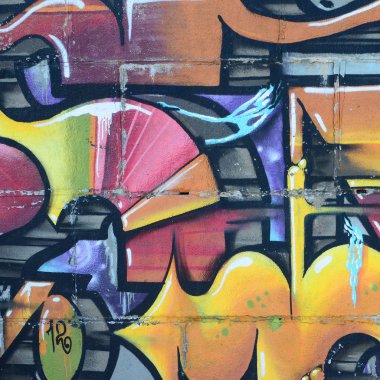 Grafiti çizimler parçası. Eski duvar boya lekeleri sokak sanatı kültür tarzı ile dekore edilmiştir. Renkli arka plan doku sıcak tonları içinde.