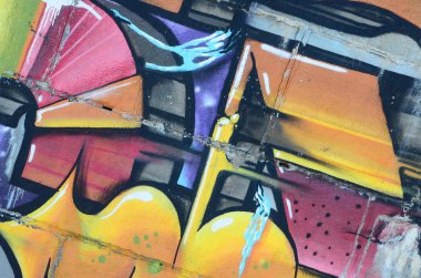 Grafiti çizimler parçası. Eski duvar boya lekeleri sokak sanatı kültür tarzı ile dekore edilmiştir. Renkli arka plan doku sıcak tonları içinde.