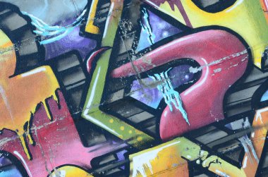 Grafiti çizimler parçası. Eski duvar boya lekeleri sokak sanatı kültür tarzı ile dekore edilmiştir. Renkli arka plan doku sıcak tonları içinde.
