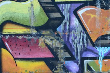 Grafiti çizimler parçası. Eski duvar boya lekeleri sokak sanatı kültür tarzı ile dekore edilmiştir. Renkli arka plan doku sıcak tonları içinde.