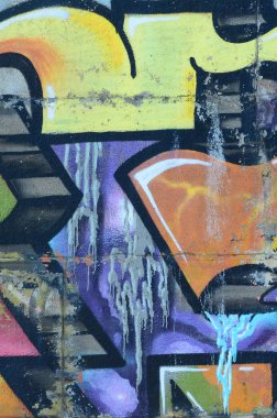 Grafiti çizimler parçası. Eski duvar boya lekeleri sokak sanatı kültür tarzı ile dekore edilmiştir. Renkli arka plan doku sıcak tonları içinde.