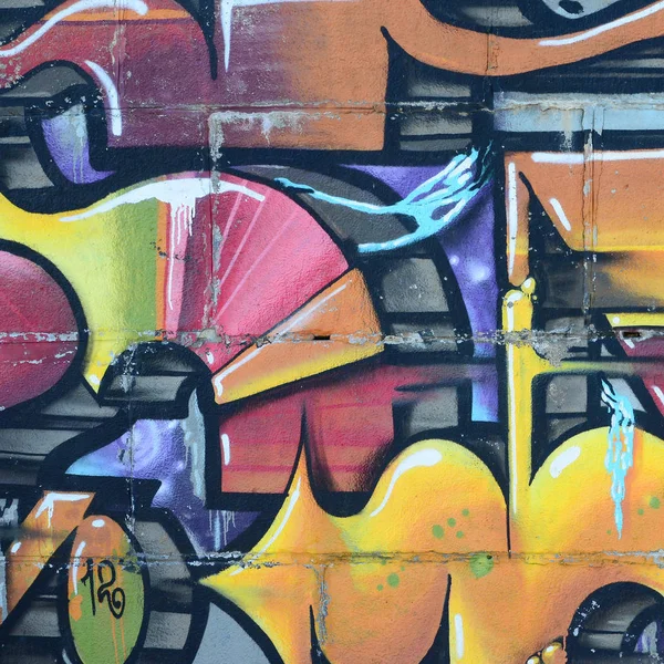 Grafiti çizimler parçası. Eski duvar boya lekeleri sokak sanatı kültür tarzı ile dekore edilmiştir. Renkli arka plan doku sıcak tonları içinde.