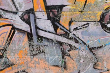 Grafiti çizimler parçası. Eski duvar boya lekeleri sokak sanatı kültür tarzı ile dekore edilmiştir. Renkli arka plan doku sıcak tonları içinde.