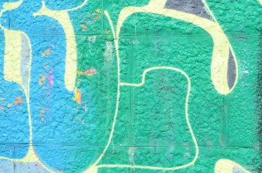 Grafiti çizimler parçası. Eski duvar boya lekeleri sokak sanatı kültür tarzı ile dekore edilmiştir. Yeşil tonlarında renkli arka plan doku.