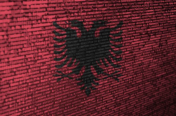 Albania flag  is depicted on the screen with the program code. The concept of modern technology and site development.