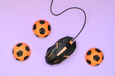 Optical gaming mouse and small orange footballs clipart