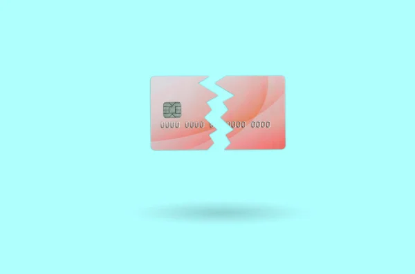 Cut and broken red credit card floating in the pastel blue space. The concept of ban to use banking services. Credit card expire end soon