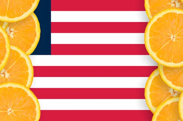 Liberia flag  in vertical frame of orange citrus fruit slices. Concept of growing as well as import and export of citrus fruits