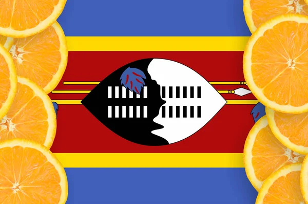 Swaziland flag  in vertical frame of orange citrus fruit slices. Concept of growing as well as import and export of citrus fruits