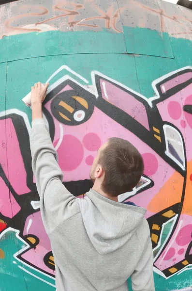 Young Guy Gray Hoodie Paints Graffiti Pink Green Colors Wall — Stock Photo, Image