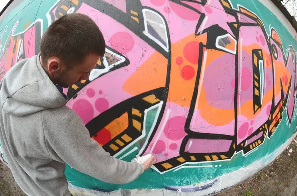 Een Jonge Man Een Grijze Hoodie Schildert Graffiti Roze Groene — Stockfoto