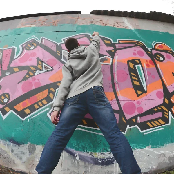 Joven Con Capucha Gris Pinta Graffiti Colores Rosa Verde Una —  Fotos de Stock