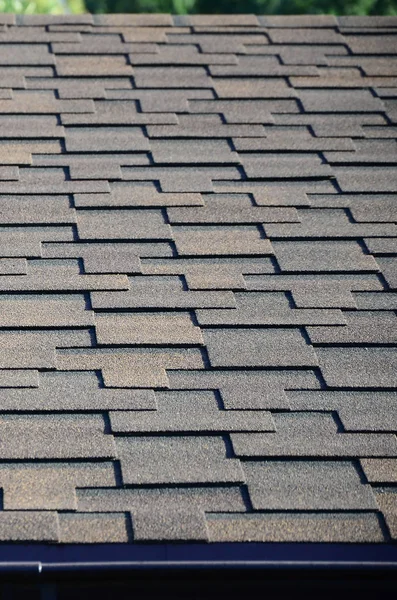 Modern roofing and decoration of chimneys. Flexible bitumen or slate shingles in rectangular shape in perspective.