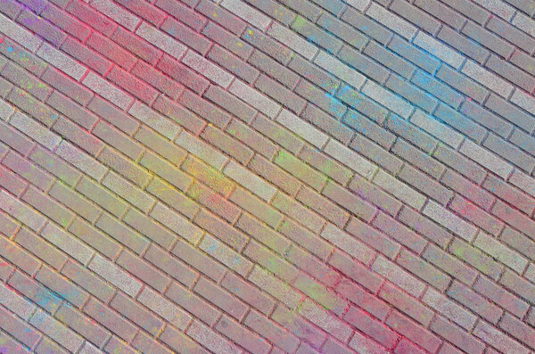 Multi colored earth, paving slabs, powder coated with dry colors at the Holi festival close up