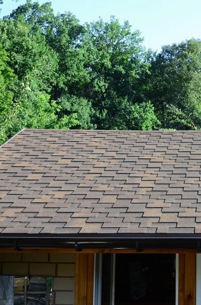 Modern roofing and decoration of chimneys. Flexible bitumen or slate shingles in rectangular shape in perspective.