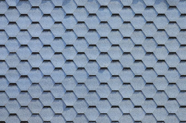 Modern roofing and decoration of chimneys. Flexible bitumen or slate shingles in hexagon shape. Top view texture