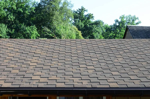 Modern roofing and decoration of chimneys. Flexible bitumen or slate shingles in rectangular shape in perspective.