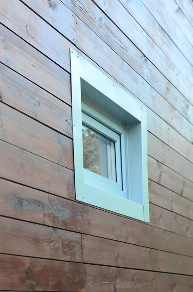 Plastic PVC window in modern passive wooden house facade wall. PVC windows are the number one in house energy efficiency