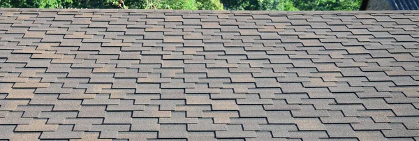 Modern roofing and decoration of chimneys. Flexible bitumen or slate shingles in rectangular shape in perspective.