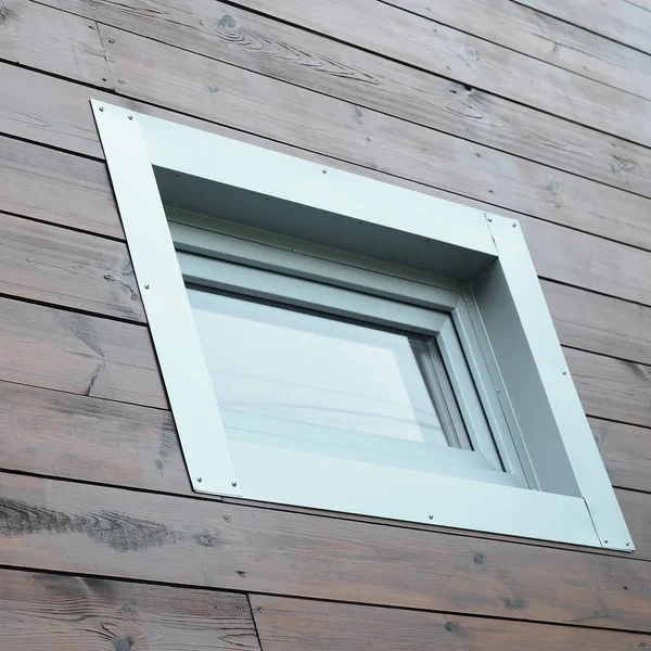 Plastic PVC window in modern passive wooden house facade wall. PVC windows are the number one in house energy efficiency