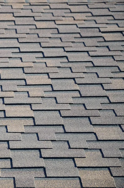 Modern roofing and decoration of chimneys. Flexible bitumen or slate shingles in rectangular shape in perspective.