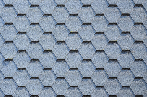 Modern roofing and decoration of chimneys. Flexible bitumen or slate shingles in hexagon shape. Top view texture