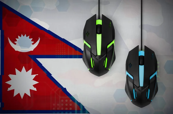 Nepal flag  and two modern computer mice with backlight. The concept of online cooperative games. Cyber sport team