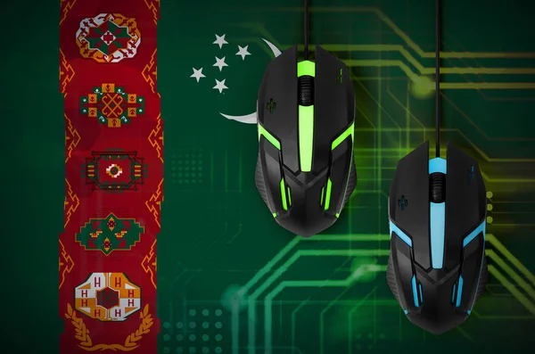 Turkmenistan flag  and two modern computer mice with backlight. The concept of online cooperative games. Cyber sport team