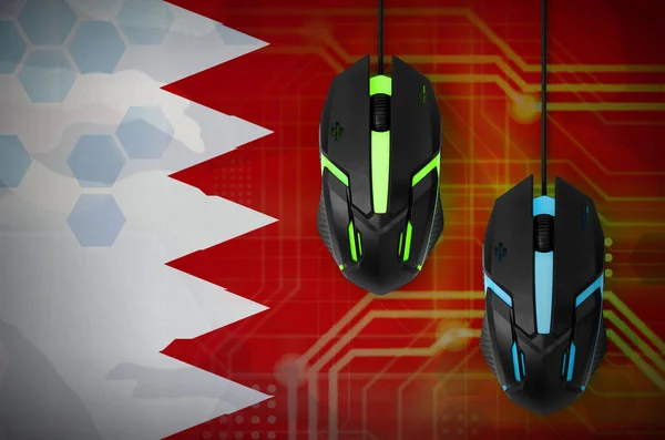 Bahrain flag  and two modern computer mice with backlight. The concept of online cooperative games. Cyber sport team