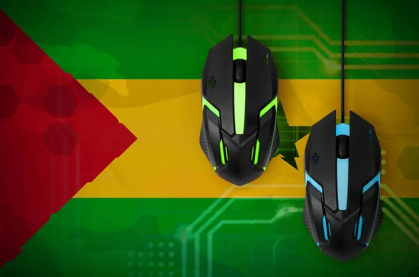 Sao Tome and Principe flag  and two modern computer mice with backlight. The concept of online cooperative games. Cyber sport team