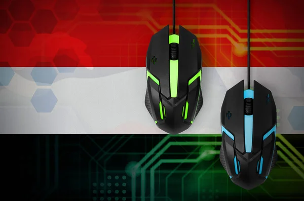 Yemen flag  and two modern computer mice with backlight. The concept of online cooperative games. Cyber sport team