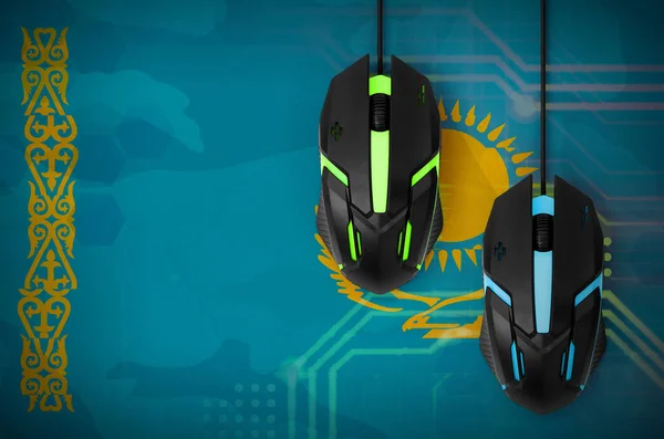 Kazakhstan flag  and two modern computer mice with backlight. The concept of online cooperative games. Cyber sport team