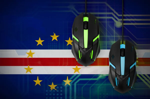 Cabo verde flag  and two modern computer mice with backlight. The concept of online cooperative games. Cyber sport team