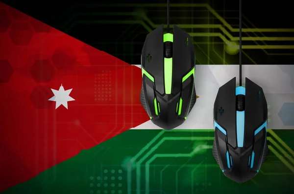 Jordan flag  and two modern computer mice with backlight. The concept of online cooperative games. Cyber sport team