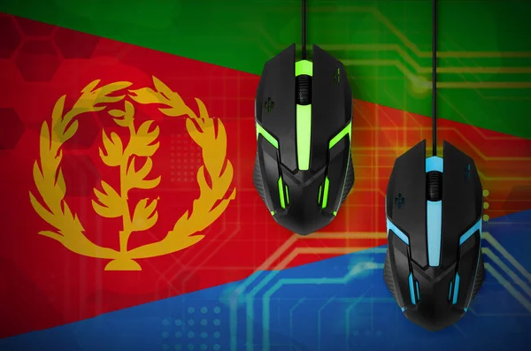 Eritrea flag  and two modern computer mice with backlight. The concept of online cooperative games. Cyber sport team