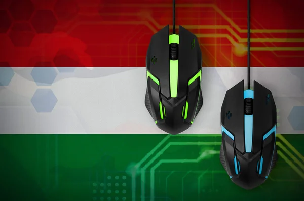 Hungary flag  and two modern computer mice with backlight. The concept of online cooperative games. Cyber sport team