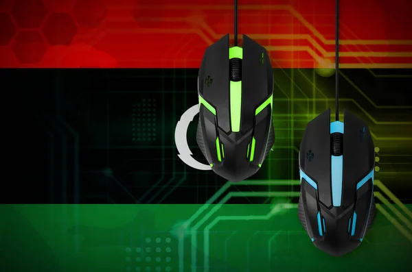 Libya flag  and two modern computer mice with backlight. The concept of online cooperative games. Cyber sport team