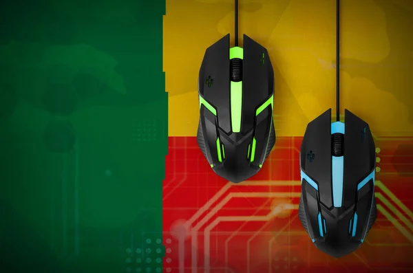 Benin flag  and two modern computer mice with backlight. The concept of online cooperative games. Cyber sport team