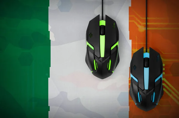 Ireland flag  and two modern computer mice with backlight. The concept of online cooperative games. Cyber sport team
