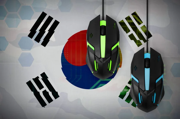 South Korea flag  and two modern computer mice with backlight. The concept of online cooperative games. Cyber sport team