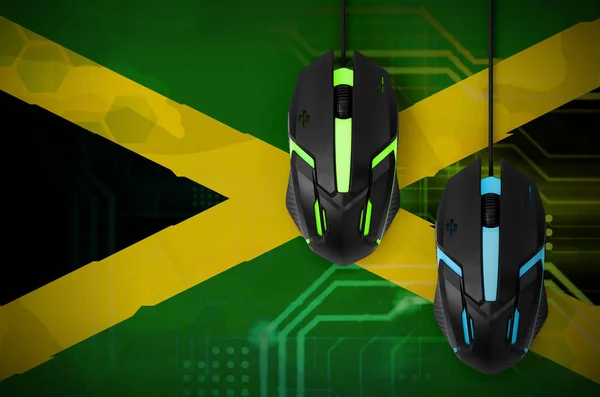 Jamaica flag  and two modern computer mice with backlight. The concept of online cooperative games. Cyber sport team