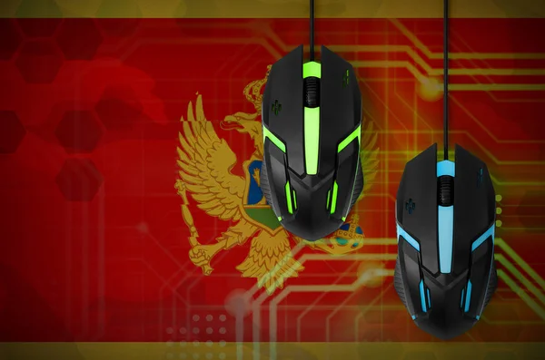 Montenegro flag  and two modern computer mice with backlight. The concept of online cooperative games. Cyber sport team