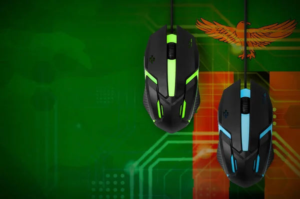 Zambia flag  and two modern computer mice with backlight. The concept of online cooperative games. Cyber sport team