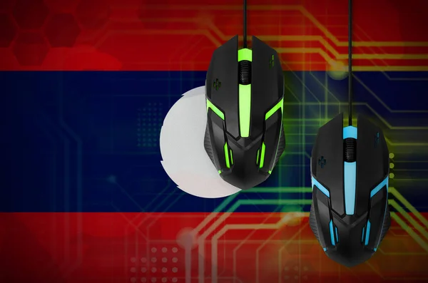 Laos flag  and two modern computer mice with backlight. The concept of online cooperative games. Cyber sport team