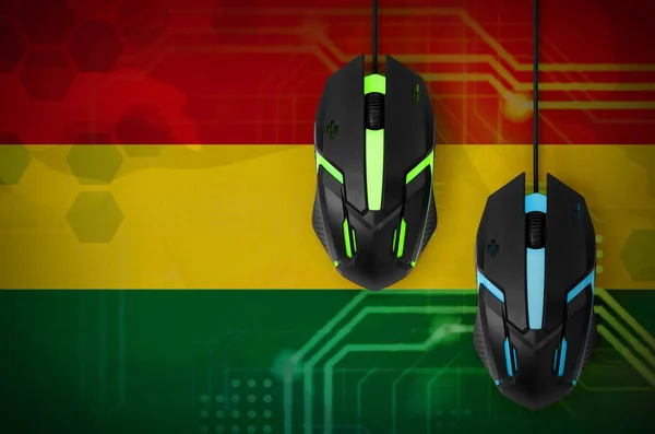 Bolivia flag  and two modern computer mice with backlight. The concept of online cooperative games. Cyber sport team