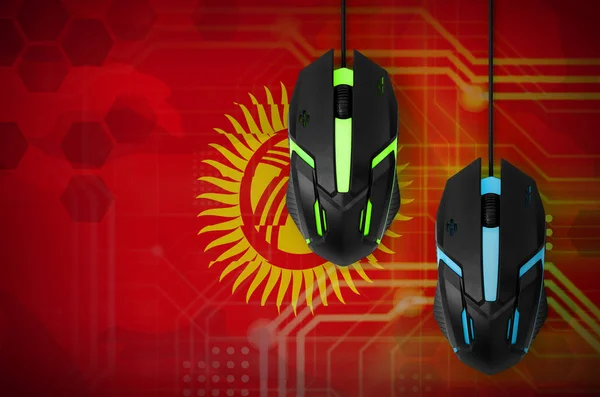 Kyrgyzstan flag  and two modern computer mice with backlight. The concept of online cooperative games. Cyber sport team